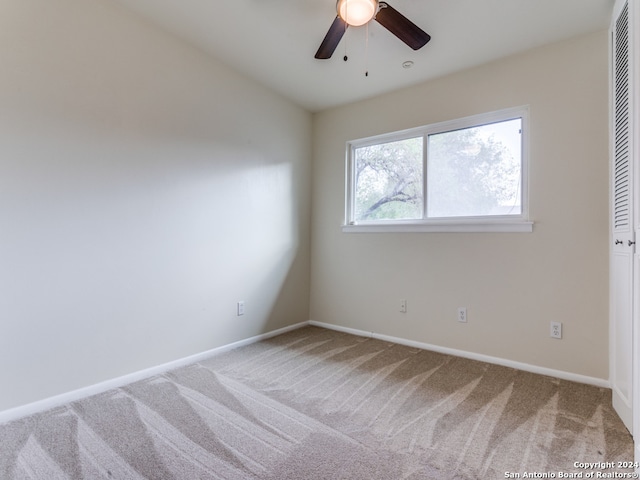 unfurnished room featuring ceiling fan and carpet flooring