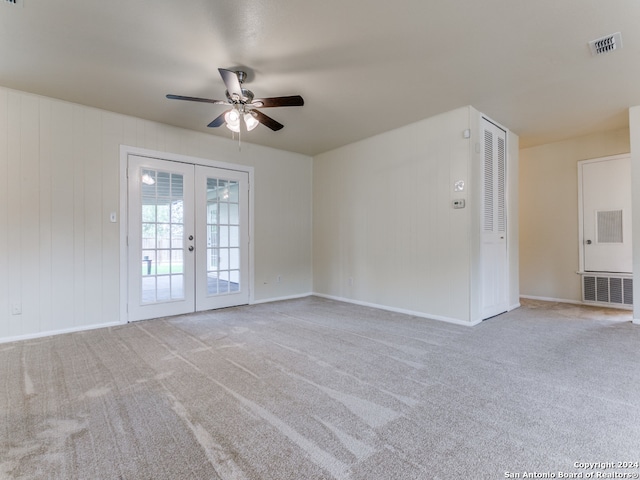 empty room featuring carpet, french doors, and ceiling fan