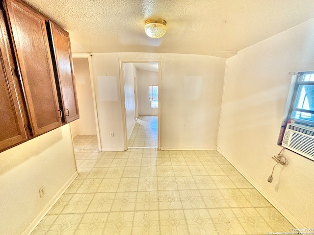 unfurnished room featuring a textured ceiling