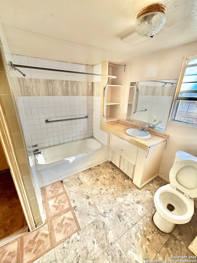 full bathroom featuring vanity, toilet, and tiled shower / bath