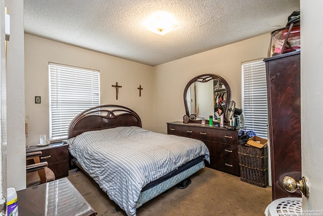 carpeted bedroom with a textured ceiling