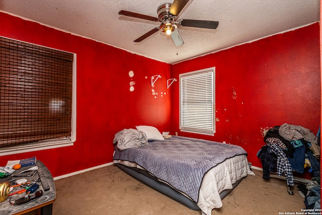 carpeted bedroom with a textured ceiling and ceiling fan