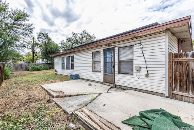 back of property with a patio and a yard