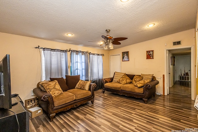 living room featuring a textured ceiling, hardwood / wood-style flooring, and ceiling fan