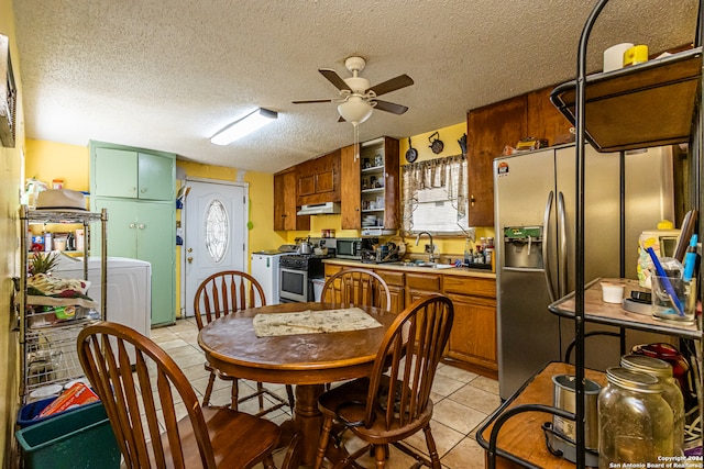 kitchen featuring stainless steel appliances, ceiling fan, a textured ceiling, and sink