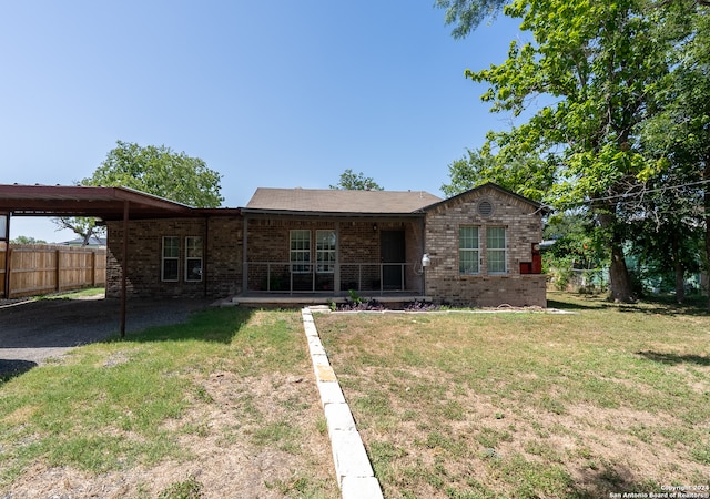 ranch-style home featuring a front yard