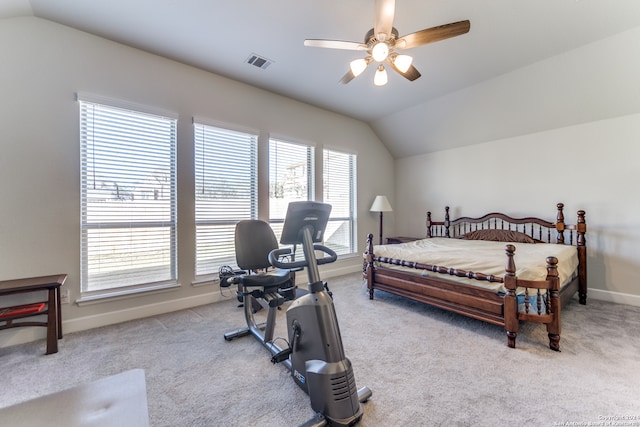 bedroom featuring ceiling fan, multiple windows, and vaulted ceiling