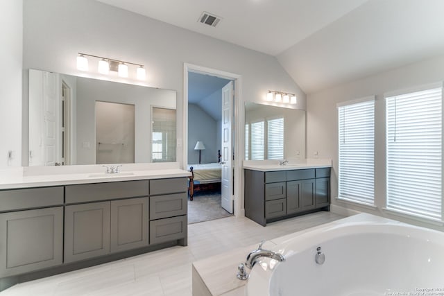 216 Paint Crk, Boerne, TX 78006 - ensuite bathroom with vaulted ceiling, a garden tub, two vanities, and a shower