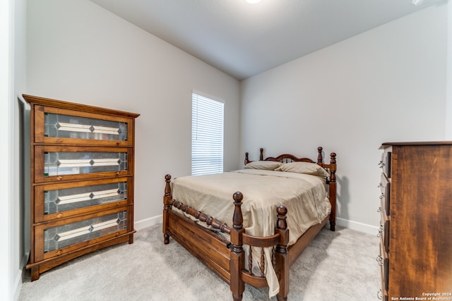 carpeted bedroom featuring lofted ceiling