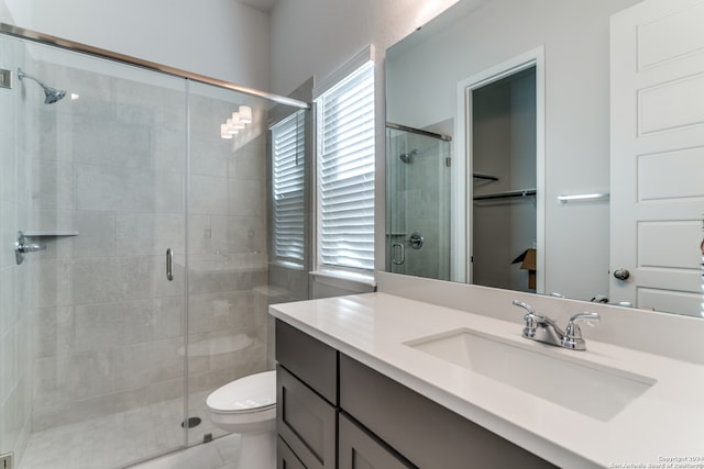 bathroom featuring walk in shower, toilet, and plenty of natural light