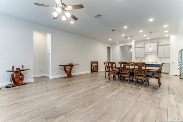 dining room featuring light hardwood / wood-style floors and ceiling fan