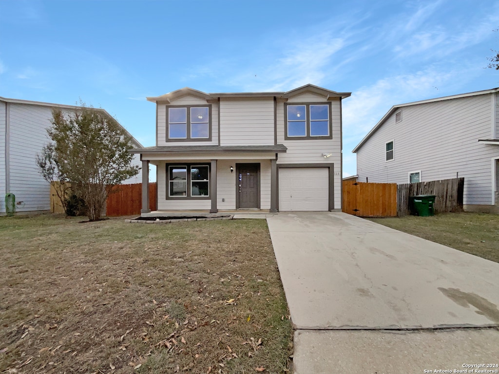 view of front property featuring a garage and a front yard