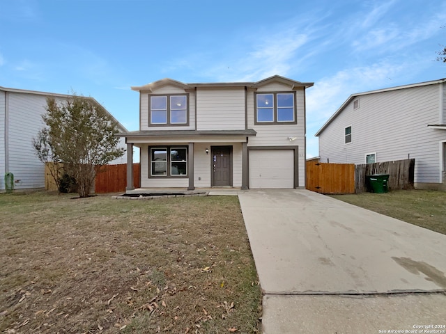 view of front property featuring a garage and a front yard