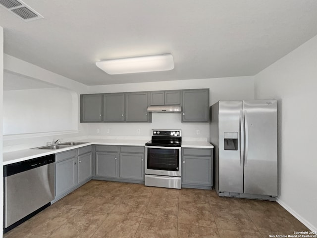 kitchen with gray cabinets, appliances with stainless steel finishes, and sink