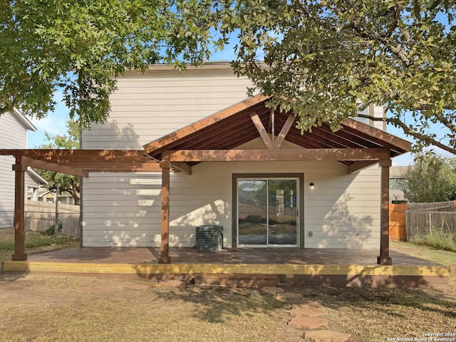 rear view of house featuring a deck