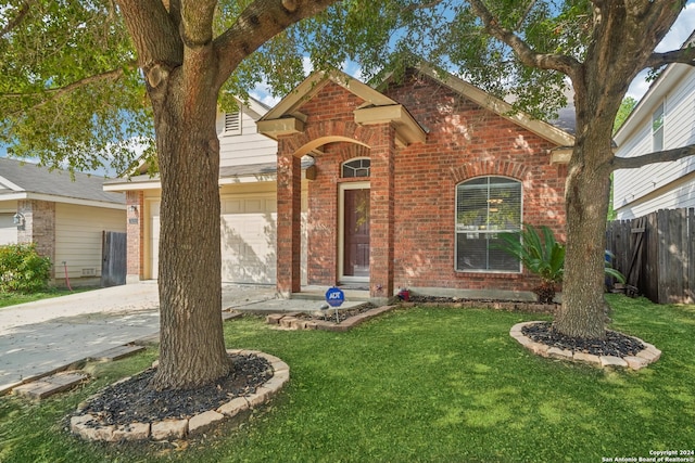 view of front of home with a garage and a front yard