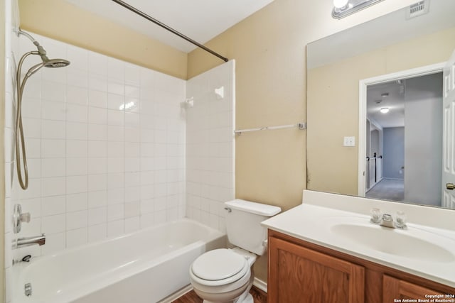 full bathroom with vanity, tiled shower / bath, and toilet