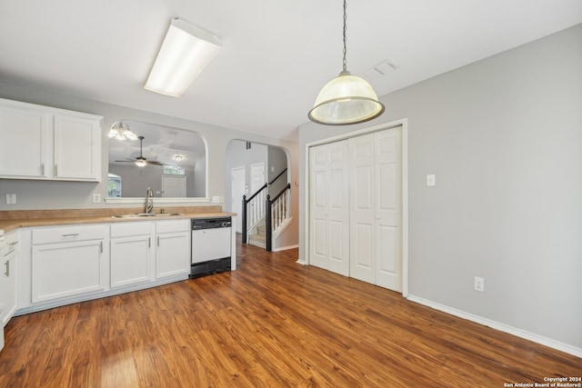 kitchen with white cabinets, hardwood / wood-style floors, dishwasher, hanging light fixtures, and sink