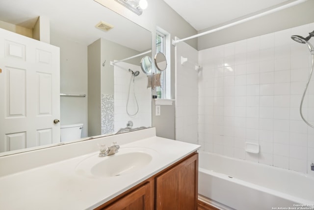 full bathroom featuring vanity, toilet, and tiled shower / bath combo