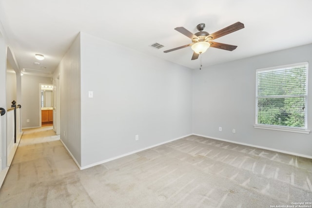 empty room with light colored carpet and ceiling fan