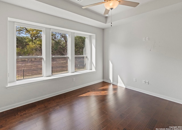 spare room with dark hardwood / wood-style flooring and ceiling fan