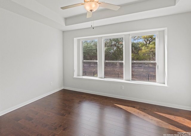 empty room featuring dark wood-type flooring and ceiling fan