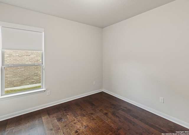 spare room featuring dark hardwood / wood-style floors