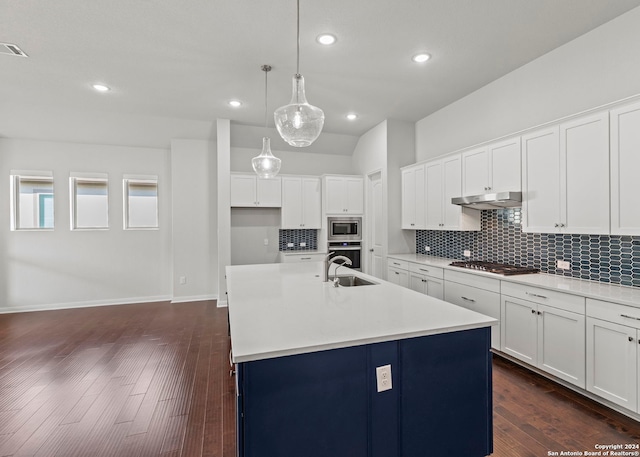 kitchen with hanging light fixtures, white cabinets, a kitchen island with sink, and dark hardwood / wood-style flooring