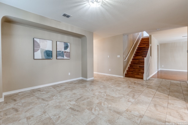 spare room with a textured ceiling