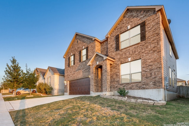 view of front of property featuring a garage and a front yard