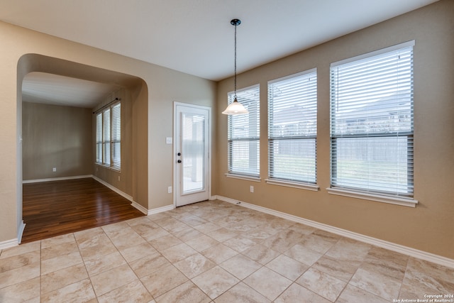 unfurnished dining area with light wood-type flooring