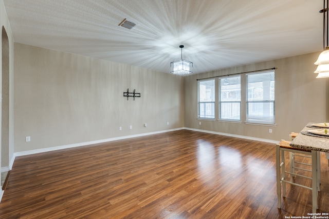 interior space with a chandelier and dark hardwood / wood-style floors