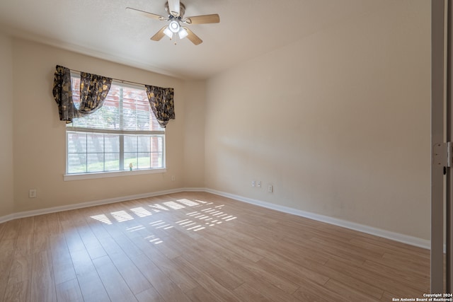 spare room with light hardwood / wood-style floors and ceiling fan