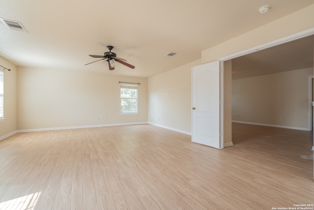 unfurnished room with ceiling fan and light wood-type flooring