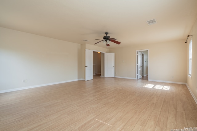 empty room with light hardwood / wood-style flooring and ceiling fan