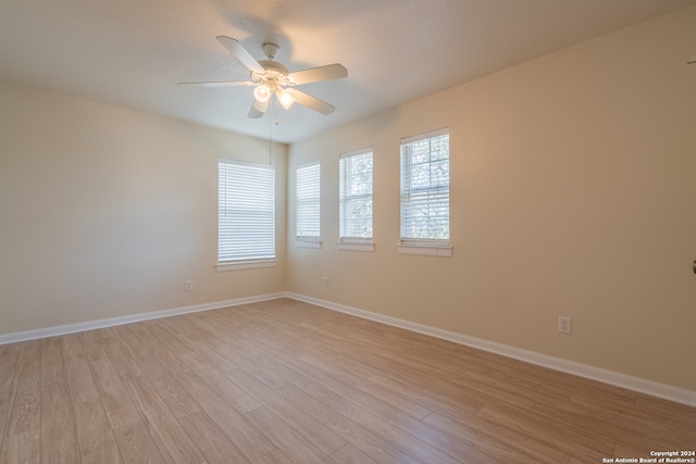 unfurnished room featuring light wood-type flooring and ceiling fan