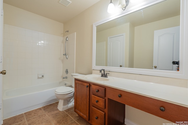 full bathroom featuring toilet, tiled shower / bath combo, vanity, and tile patterned flooring