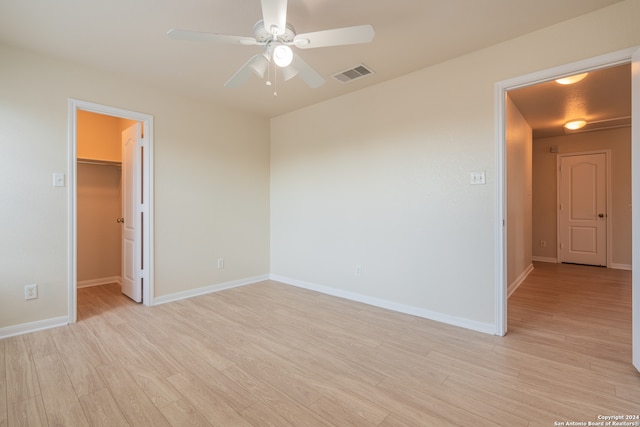 spare room with light hardwood / wood-style flooring and ceiling fan