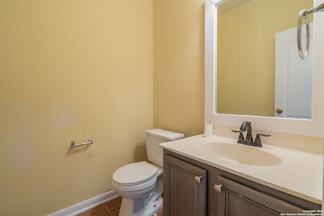 bathroom with tile patterned flooring, vanity, and toilet