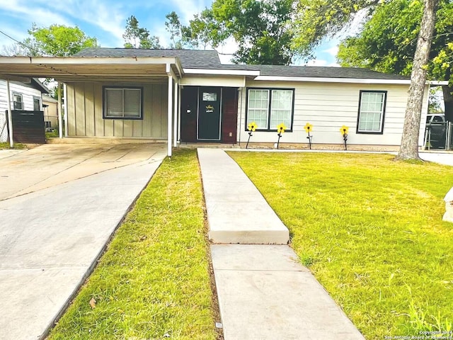 single story home featuring a front yard and a carport