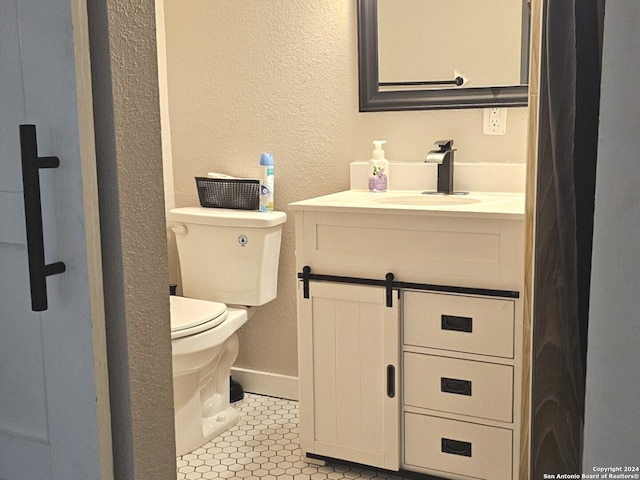 bathroom featuring vanity, tile patterned floors, and toilet