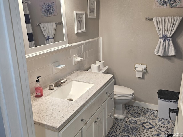 bathroom with toilet, backsplash, vanity, and tile patterned flooring