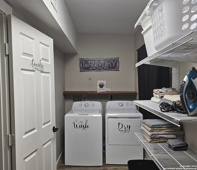 laundry room featuring hardwood / wood-style flooring and independent washer and dryer