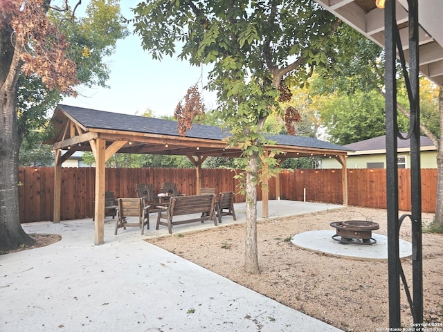 view of community with a patio area, an outdoor fire pit, and a gazebo