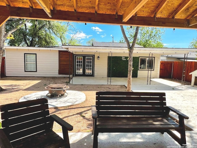 view of patio featuring an outdoor fire pit and french doors