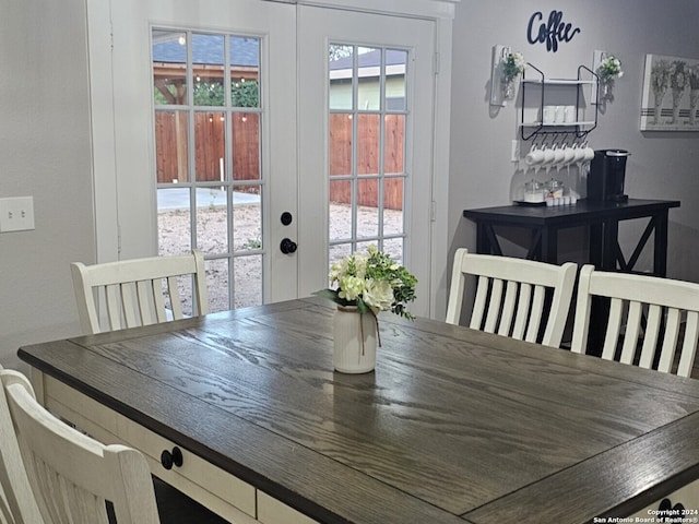 dining room featuring a healthy amount of sunlight and french doors