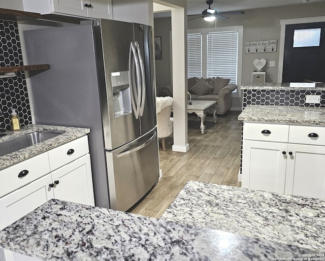 kitchen with tasteful backsplash, ceiling fan, light hardwood / wood-style flooring, white cabinets, and stainless steel fridge with ice dispenser