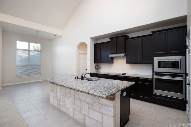 7270 Lunar Eclipse, Converse, TX 78109 - kitchen featuring stainless steel appliances, a sink, light tile patterned floors, under cabinet range hood, and high vaulted ceiling