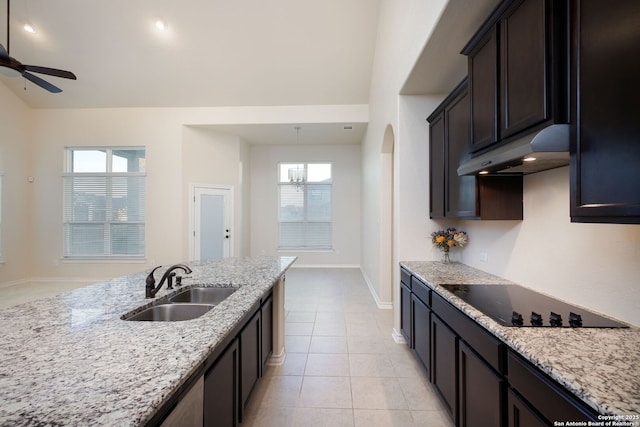 7270 Lunar Eclipse, Converse, TX 78109 - kitchen featuring under cabinet range hood, black electric cooktop, a sink, light stone counters, and vaulted ceiling