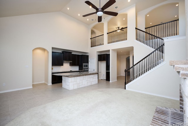 7270 Lunar Eclipse, Converse, TX 78109 - unfurnished living room featuring a ceiling fan, high vaulted ceiling, stairway, arched walkways, and recessed lighting